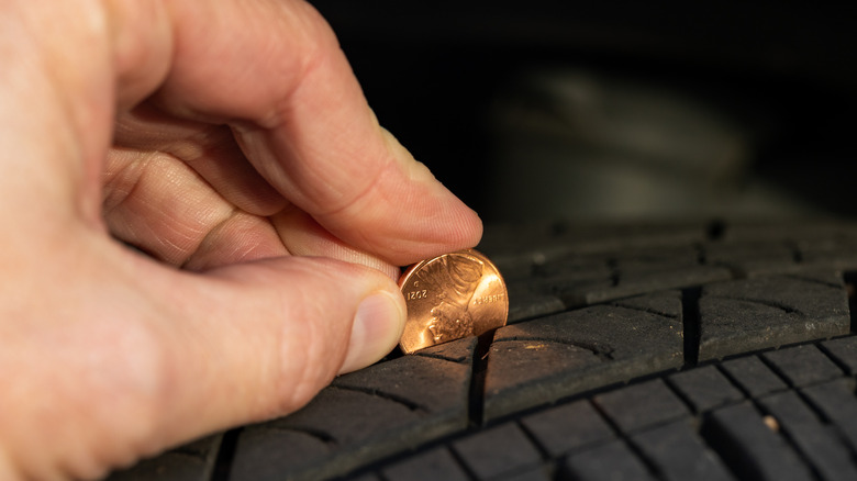 Using a penny to check tread depth on a tire