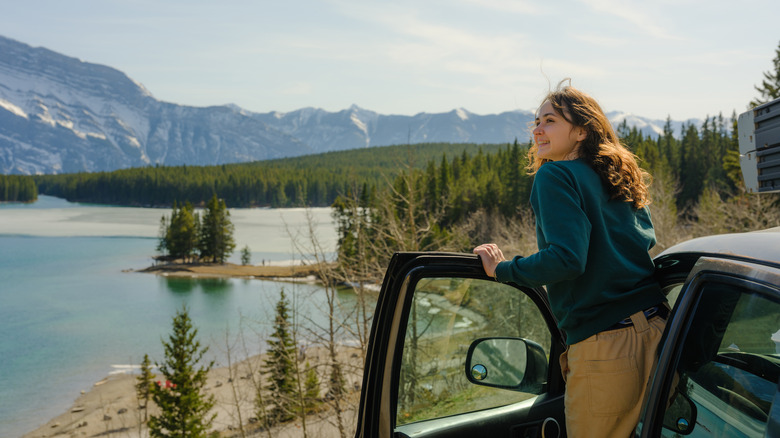 A woman pulled over to the side of the road by the shoreline in Banff