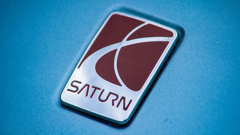 Cary, North Carolina - August 27 2025: A Gleaming Saturn Automobile Emblem Mounted On A Sedan Hood Trunk Lid
