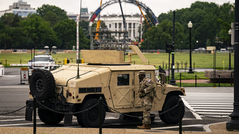 A US National Guard Humvee is parked on the National Mall as construction on "The Claw" a 90-foot-tall, open-air, dome-like lighting and staging grid to house the UFC Octagon occurs on the South Lawn of the White House on May 25, 2026 in Washington, DC.