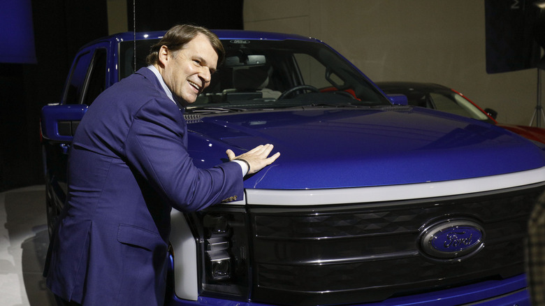 Ford CEO Jim Farley pats a Ford F-150 Lightning truck before announcing at a press conference that Ford Motor Company will be partnering with the world's largest battery company, a China-based company called Contemporary Amperex Technology, to create an electric-vehicle battery plant in Marshall, Michigan, on February 13, 2023 in Romulus, Michigan.