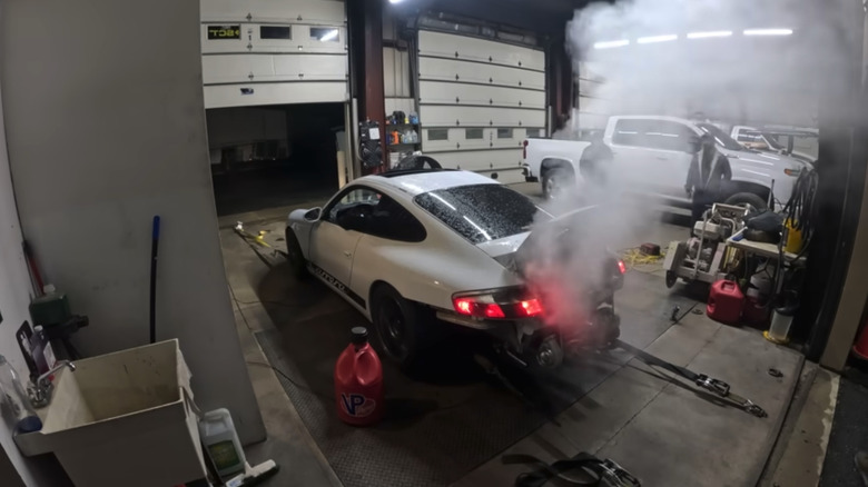 Stay Tuned has its Junkyard LS-swapped Porsche 911 on the dyno producing a little smoke in a garage.