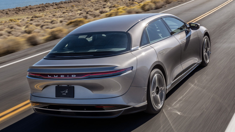 Photo of a Lucid Air being driven along a highway at speed
