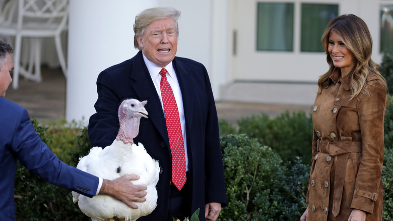 U.S. President Donald Trump gives a presidential 'pardon' to the National Thanksgiving Turkey Butter during the traditional event with first lady Melania Trump (R) in the Rose Garden of the White House November 26, 2019 in Washington, DC.