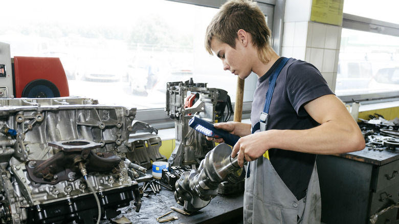 A mechanic rebuilding an engine