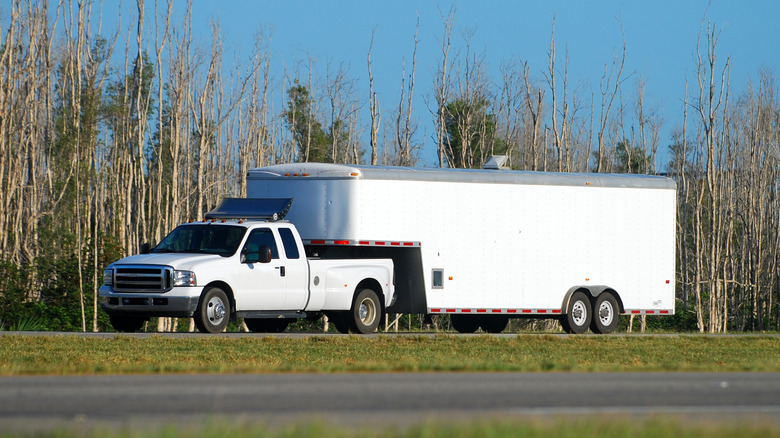 A heavy duty pickup truck towing a huge trailer