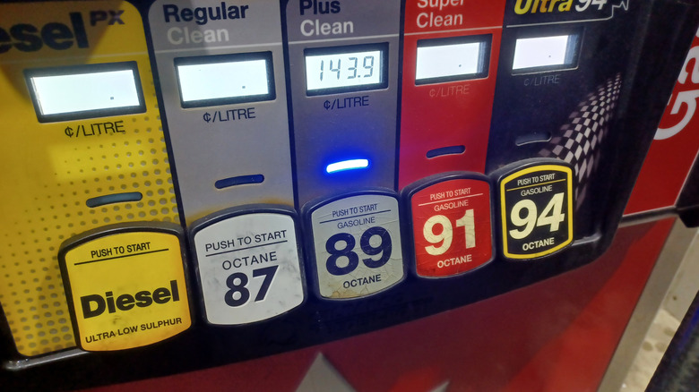 A fuel pump dispenser displaying different octane selections for gasoline and ultra-low sulphur diesel at a gas station.
