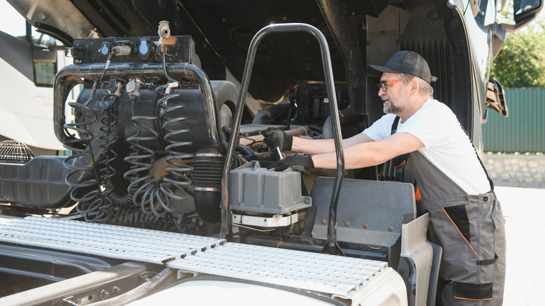 Truck mechanic rebuilding a heavy duty truck diesel engine