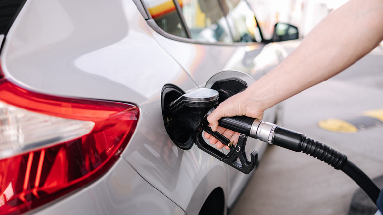 Man refueling the car at a gas station.