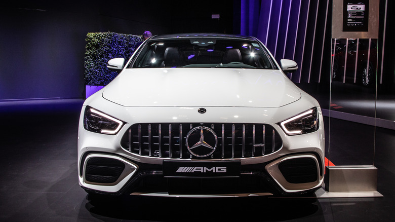 A front-end view of a white Mercedes AMG GT 53 4-door on display