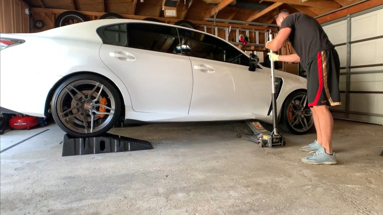 A screenshot of the notorious white Lexus after it drops off of the floor jack.
