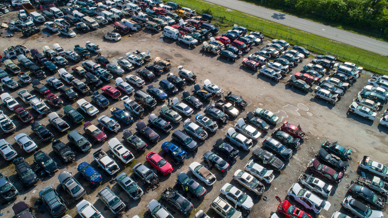 An organized car parts junkyard lot viewed from the sky