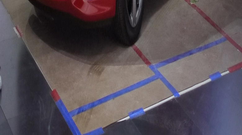 Front-quarter shot of a red Chevrolet Sonic inside a building