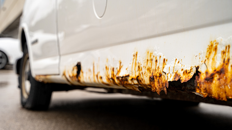 A car's sill that has completely rotted out