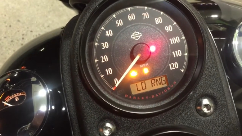 A Harley-Davidson's LO RNG light showing on a bike's odoometer