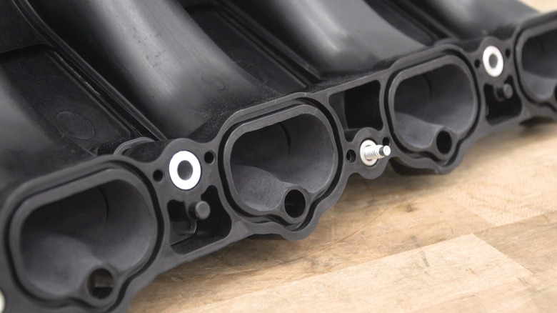 The intake ports on a Ford Coyote V8 intake manifold after being ported and polished