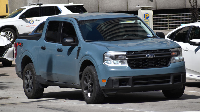A blue Ford Maverick FX4 pickup truck parked in a public parking lot.