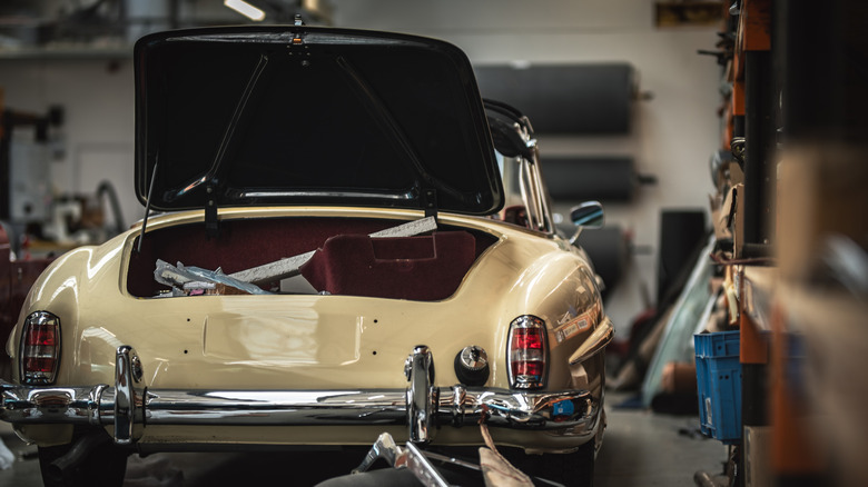 A classic car parked inside a garage.