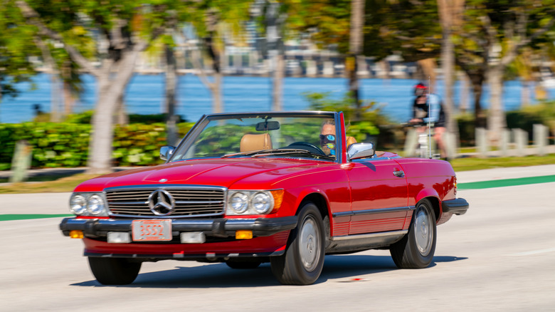 A red Mercedes convertible driving near Miami, Florida.