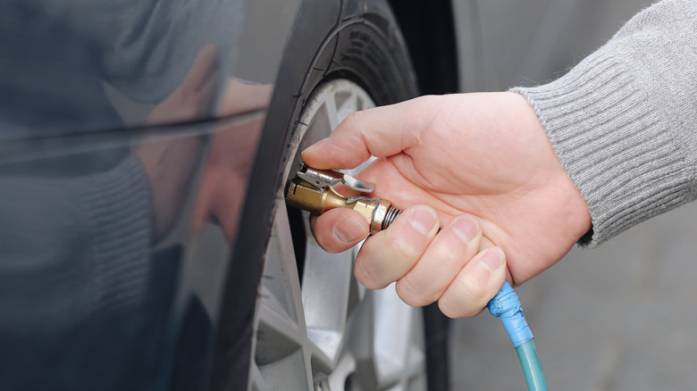 Close-up of someone checking their tire pressure.