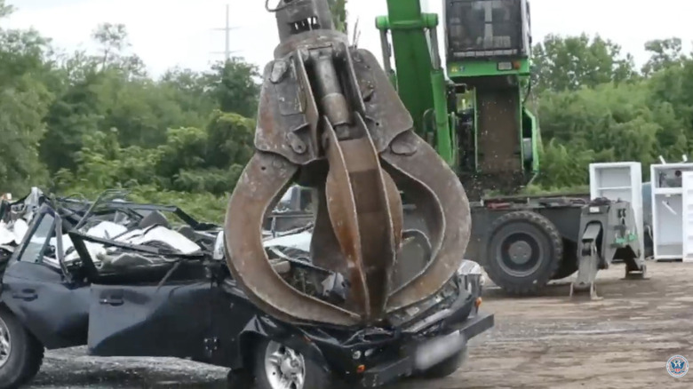A Land Rover Defender being destroyed for its counterfeit documentation.