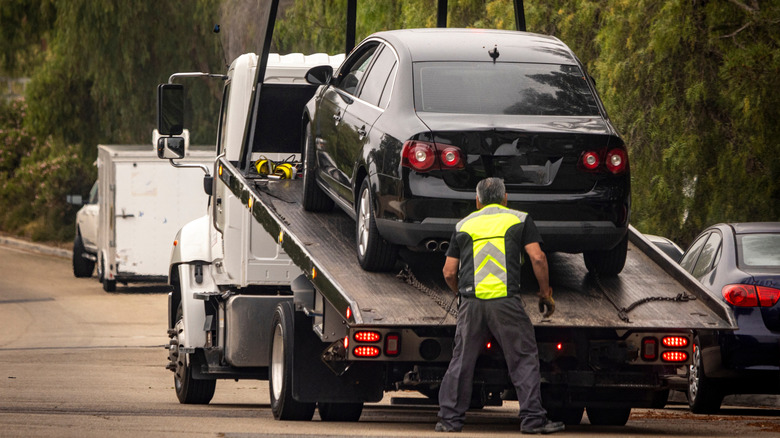 Car being loaded onto a tow truck.