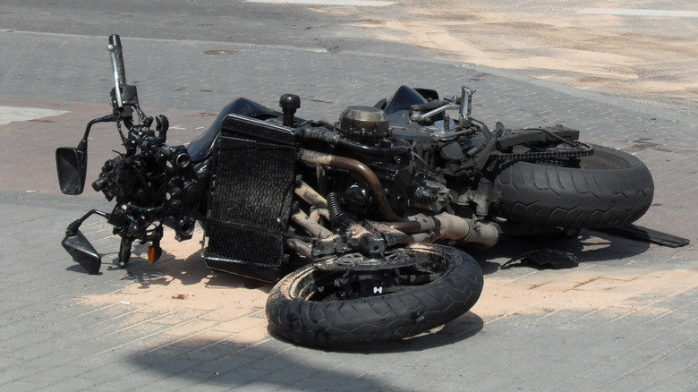 A crashed motorcycle lying in a roadway