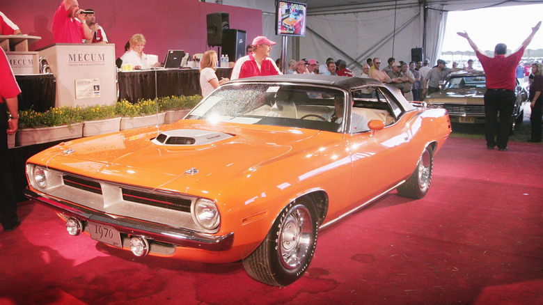 An orange 1970 Plymouth Barracuda being sold at auction