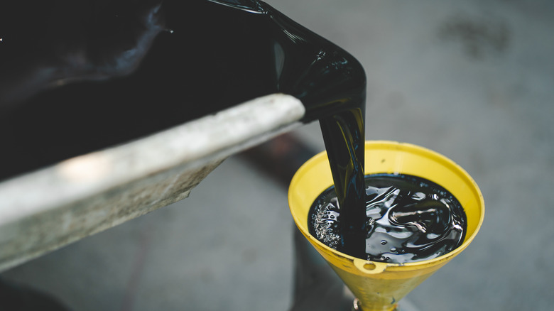 Used engine oil being collected for recycling.