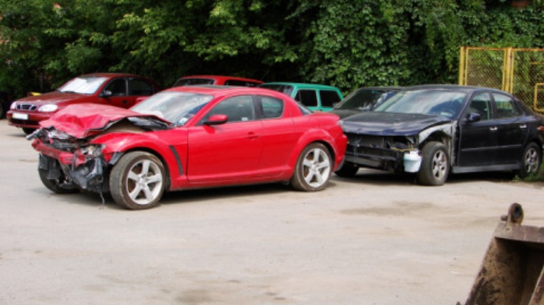 Damaged cars in a parking lot.