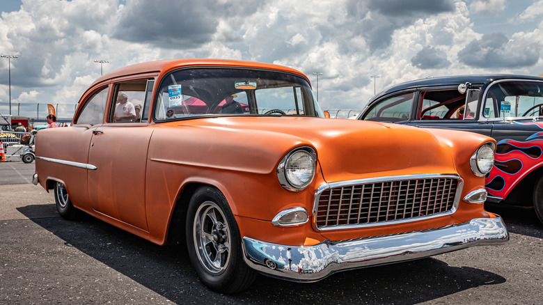 An orange 1955 Chevrolet 150 two-door sedan