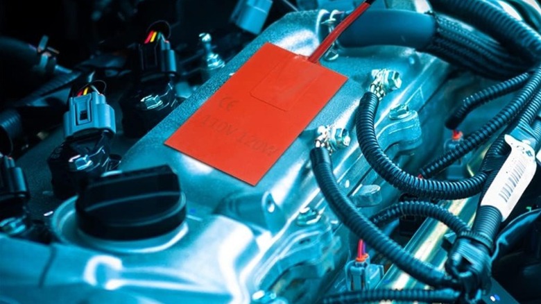 An adhesive engine block heater pad