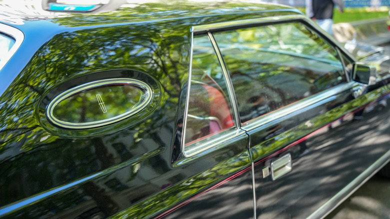 A classic car with an opera window