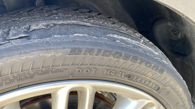 A close up photo of a Bridgestone tire with the tread separated from the tire