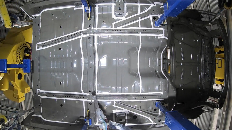 An automated seam sealer applicator in a car factory