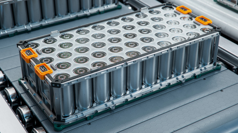 An EV battery pack without its protective casing on a conveyor belt.