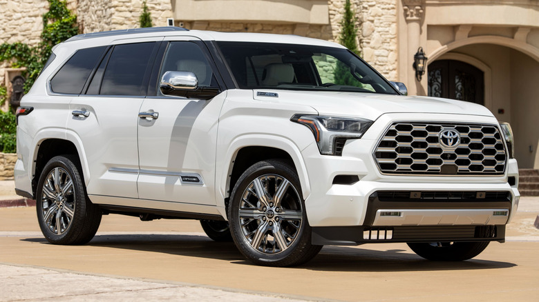 Wind Chill Pearl 2025 Toyota Sequoia Capstone parked on a driveway with a building in the background