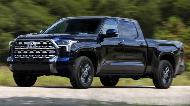 Blueprint Toyota Tundra Platinum driving on a paved road with trees in the background