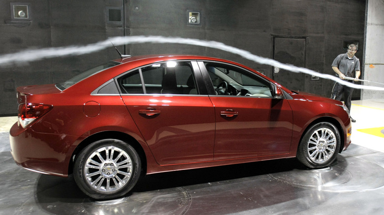 A car in a facility having its aerodynamics tested