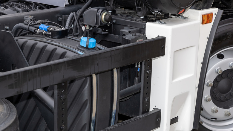 A semi truck showing its diesel exhaust fluid (DEF) filler tank