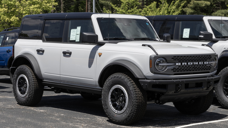 A white 2026 Ford Bronco Badlands 4-door parked at a dealership.