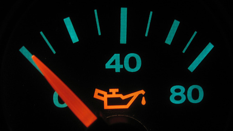 The dashboard oil meter in a car showing low oil pressure
