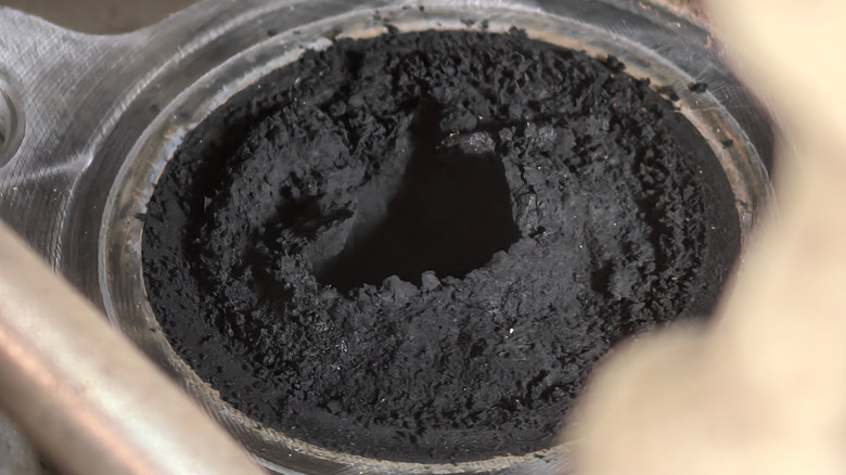 A close-up of a badly clogged EGR valve