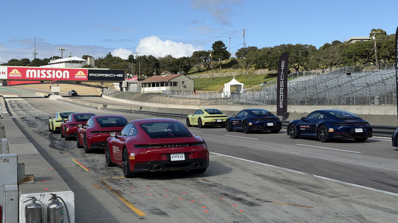 A bunch of Porsche 911s in the pit at Laguna Seca