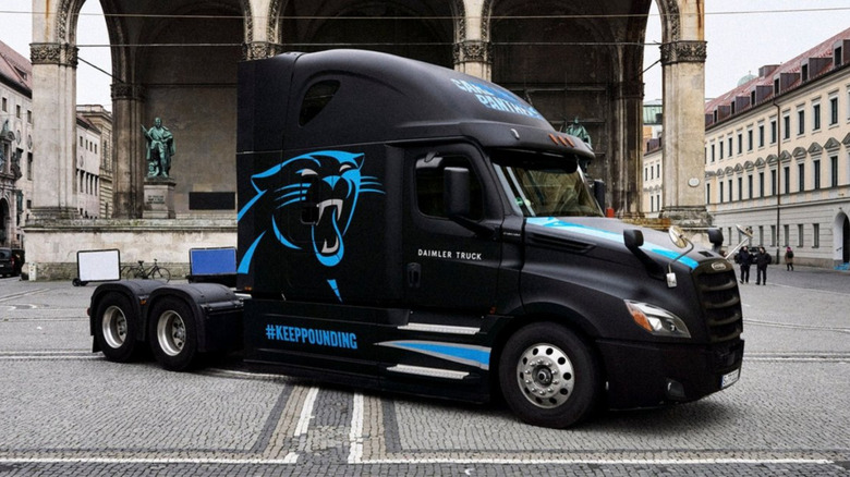 Freightliner Cascadia wearing Carolina Panthers livery at German NFL game