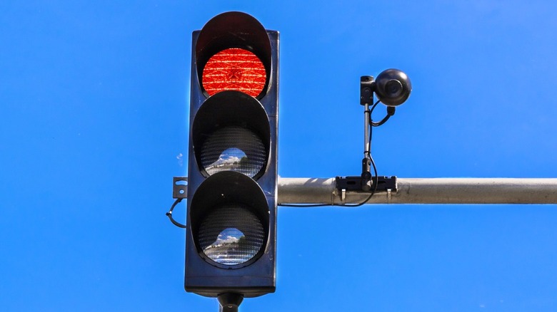 Traffic signal next to a red-light camera