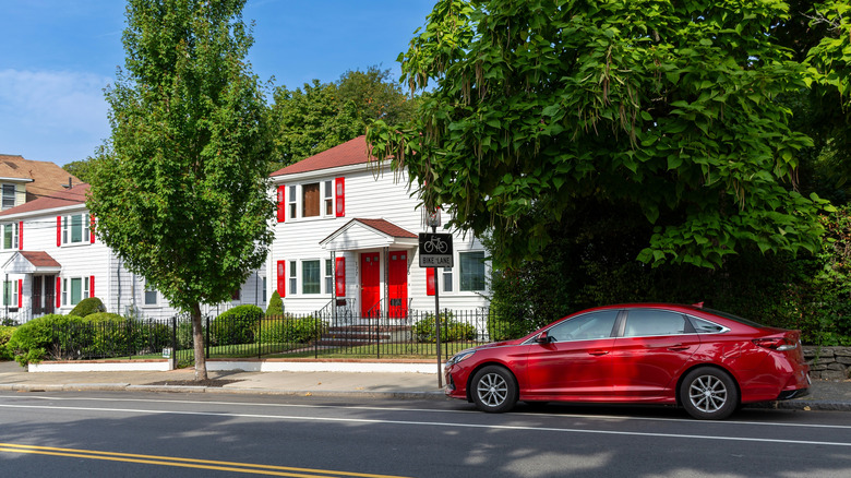 Harmonious red tones of car and houses on a serene street in the Brighton area of Boston, Massachusetts, USA