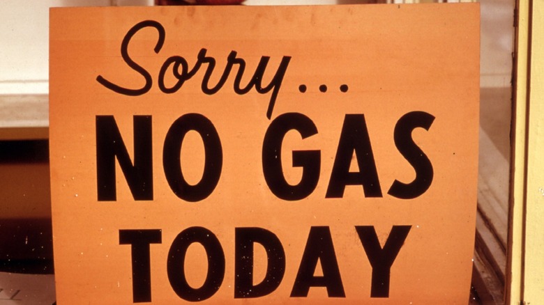 A sign at a gas station says, 