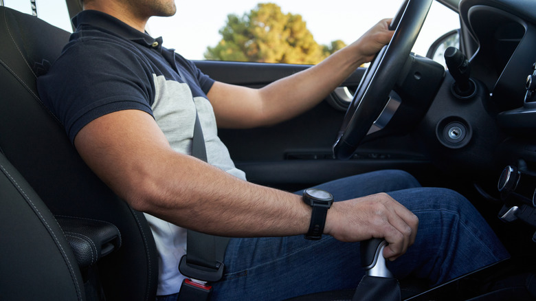 Male driver shifting center-mounted automatic transmission lever