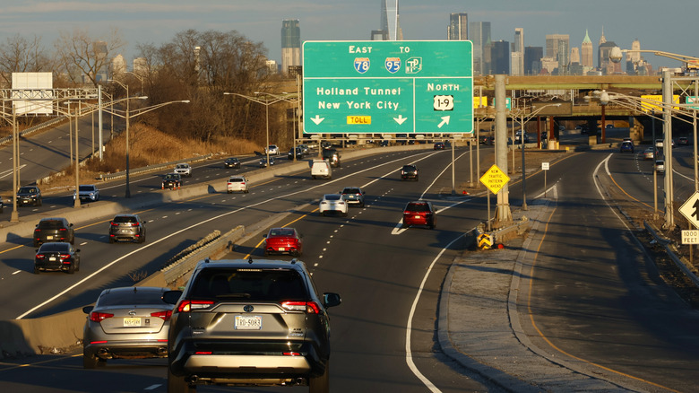 Cars approaching Holland Tunnel entrance to New York City at sunset